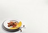 Lamb liver with tomato, onions, pine nuts and capers fruits on plate on white background