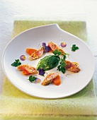 Parsley mousse with rabbit back and herbs on plate