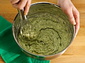 Herbs and butter mixture being stirred with whisk, step 3