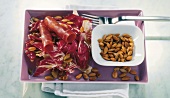 Radicchio with pumpkin seed vinaigrette and ham on serving plate
