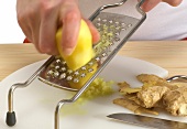 Ginger being scraped on kitchen grater, step 2