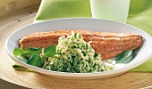 Close-up of roasted fillet of char with herb rice on plate