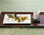 Green asparagus with pine honey in filo pastry on plate