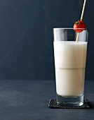 Mary White with white tomato juice with cherry tomato in glass