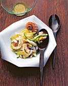 Octopus salad with cucumber and celery on plate