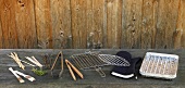 Grill accessories, grill tools, pliers and glove on wooden table