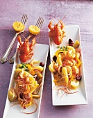 Crayfish potato salad with lemons on serving dish