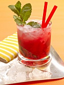 Raspberry mojito with mint, ice and red rum in glass