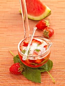 Juicy melon punch with watermelon and strawberries in glass ladle