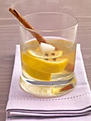 Whiskey toody with whiskey, lemon, cinnamon and cloves in glass