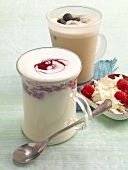 Gingerbread milk and hot white chocolate with raspberries in glass