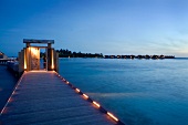 Illuminated dock huts on Dhigufinolhu island, Maldives