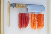 Slices of salmon with knife on cutting board, step 1