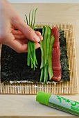 Preparation of rainbow sushi on nori sheet and sushi mat, step 2