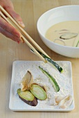 Different vegetables in flour while preparing squid tempura, step 2