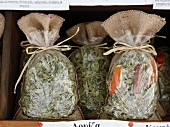 Three condiment bags on shelf at Pelion market, Greece