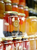 Sweet fruit with almonds in glass jars at Pelion market, Greece