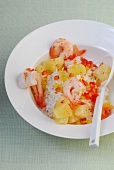 Rice salad with shrimp, peppers and pineapple in serving dish