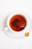 Tea cup with tea bag, overhead view