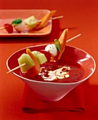 Close-up of Spicy tomato soup with cantaloupe, papaya and mozzarella in bowl