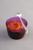 Chilli sauce with spoon in bowl