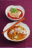 Fish fillet in tomato sauce and squid stew in bowls