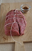 Chateaubriand meat tied up with string on serving board, step 1