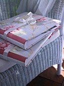Photo albums with fabric rose lying on chair