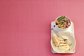 Bean salad with halloumi on pink background