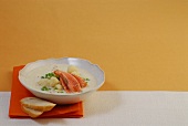 Bowl of cauliflower cream soup with salmon