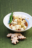Tofu with spicy ginger and green Thai chili peppers in bowl