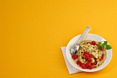 Poppy seed noodles with raspberries on plate