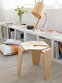 Table lamp made of wood on shelf and stool