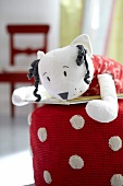 Stuffed cat on crocheted pouf