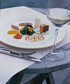 Watercress salad with lake char and caviar on plate