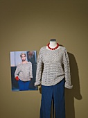 Crochet pullover and grey pants on mannequin