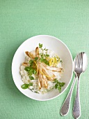 Asparagus risotto with chervil salad on plate