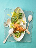 Salad with fried salmon, cucumber and chanterelle mushrooms