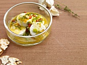 Marinated goat cheese in glass bowl