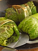 Close-up of stuffed savoy cabbage leaves while preparing savoy roulades, step 3
