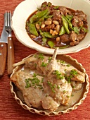 Lamb with beans and rabbit ragout with chives in serving dishes