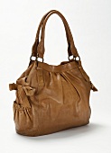 Close-up of brown leather handbag with loops side