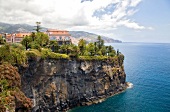 View of Hotel Reid's Palace at Atlantic rocky coast in Funchal, Madeira, Portugal