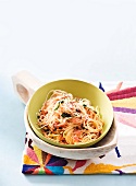 Spaghetti pasta with tomato and coriander sauce in serving bowl
