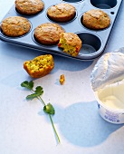 Spicy meal muffins with tomatoes and coriander in baking dish, Indian fast food