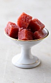 Bowl of strawberry jelly cubes with sugar