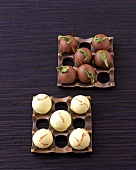 Milk chocolates garnished with basil and white chocolates garnished with saffron