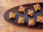 Pieces of marzipan apricot chocolates with dried apricots on tray