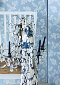 Crystal chandelier with fabric on white wooden chair