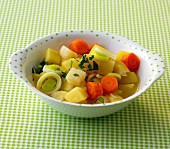 Bouillon potatoes with carrots and leeks in serving bowl